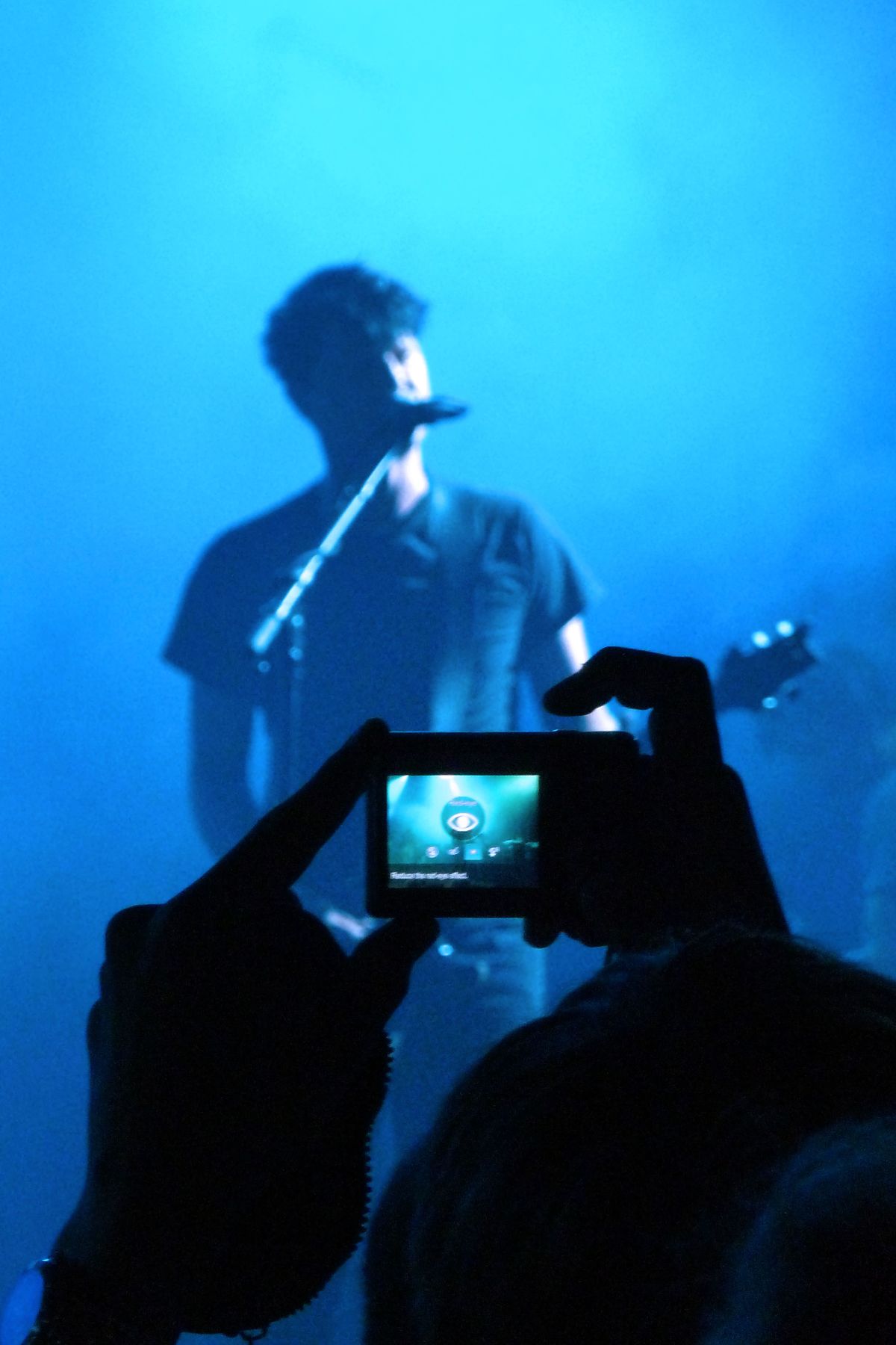 Person taking photo in concert